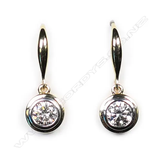 A pair of 18ct white gold and diamond solitaire earrings,