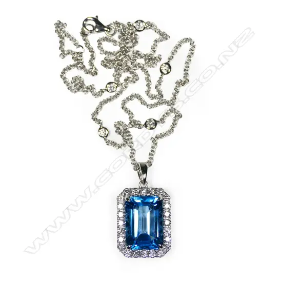 An 18ct white gold topaz and diamond cluster pendant on 18ct white gold chain,