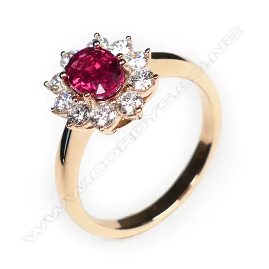 An 18ct rose gold ruby and diamond cluster ring,