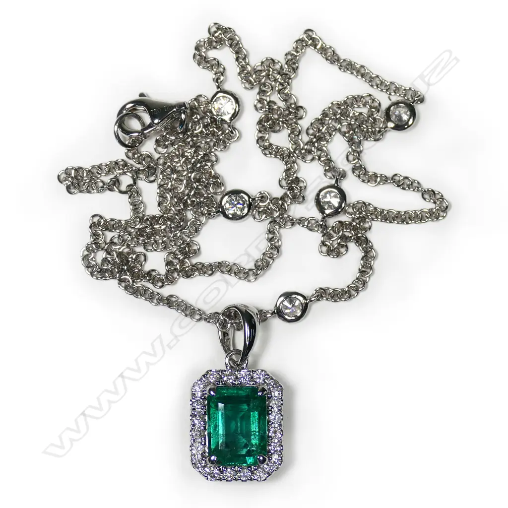 An 18ct white gold emerald and diamond cluster pendant on chain, Image 1++