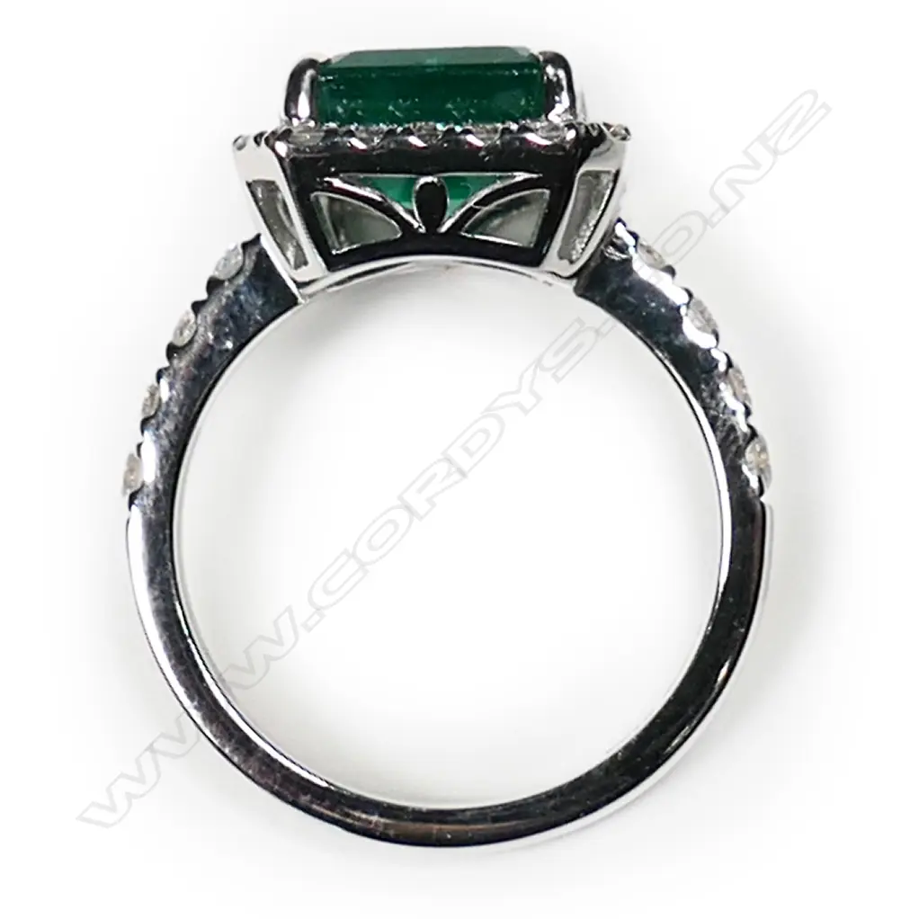 @ An 18ct white gold emerald and diamond cluster ring Image 1++