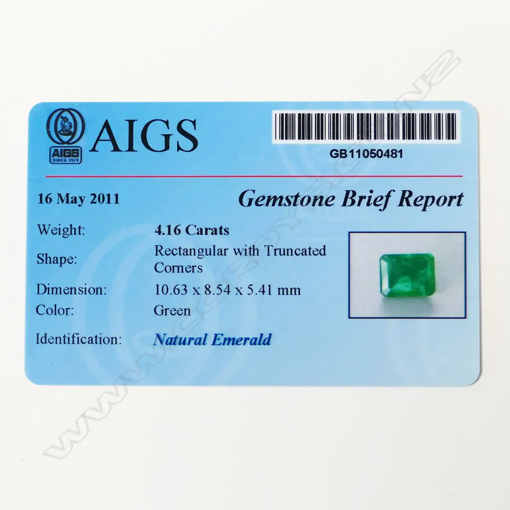 @ An 18ct white gold emerald and diamond cluster ring Image 1++