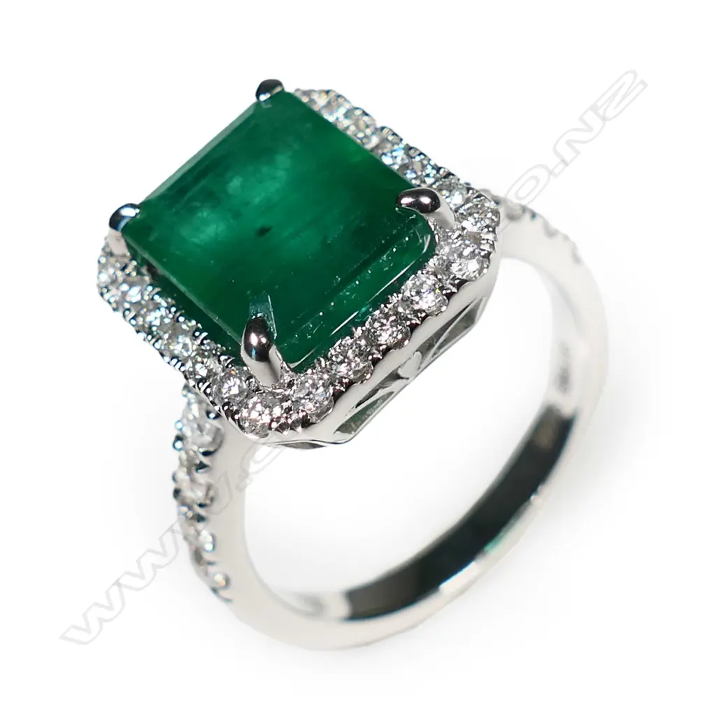@ An 18ct white gold emerald and diamond cluster ring Image 1++