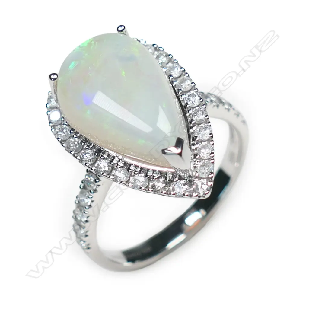 A 14ct white gold opal and diamond halo ring, Image 1++