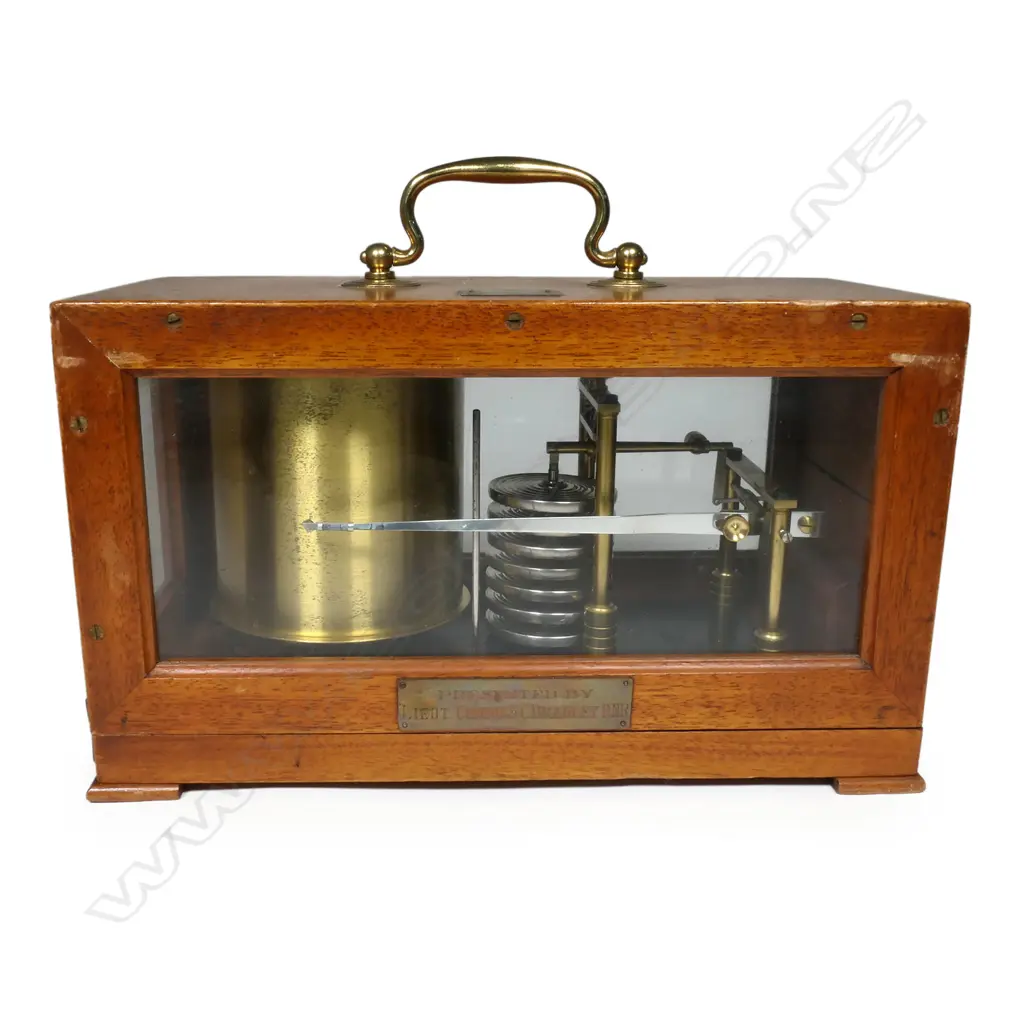 A WW2 German military barograph, in mahogany case with three glazed panels, the cover with small plaque engraved with a swastika above 'M' above '2745', the front with plaque engraved 'Presented by Lieut. Comdr S.C. Bradley RNR'. 285 x 140 x 165mm. Provenance: ex The Jack Thornton estate collection. Image 1++