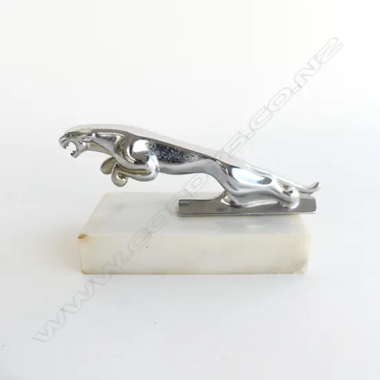 Chrome Jaguar car mascot, L.120mm on marble base (some chips).