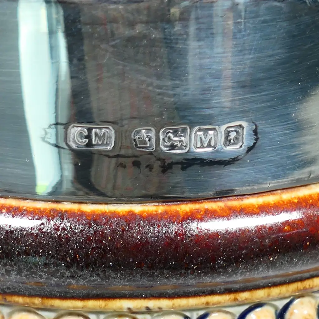 A Doulton Lambeth stoneware jug, incised decoration of papyrus in the ancient Egyptian manner, blue and grey ground, silver rim - Sheffield 1879 by Charles Mappin. H.240mm. Image 1++