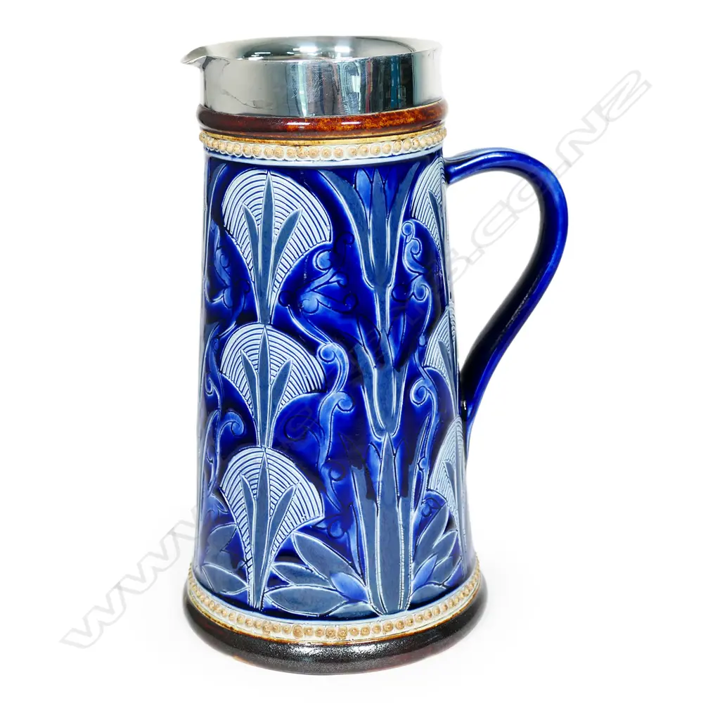 A Doulton Lambeth stoneware jug, incised decoration of papyrus in the ancient Egyptian manner, blue and grey ground, silver rim - Sheffield 1879 by Charles Mappin. H.240mm. Image 1++