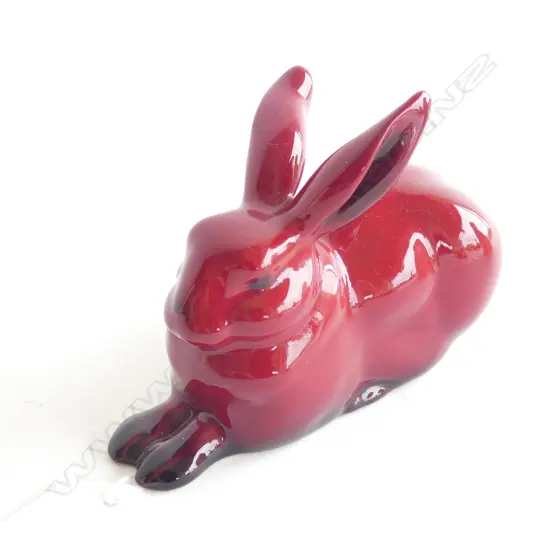 A Royal Doulton flambé seated rabbit. L.110mm