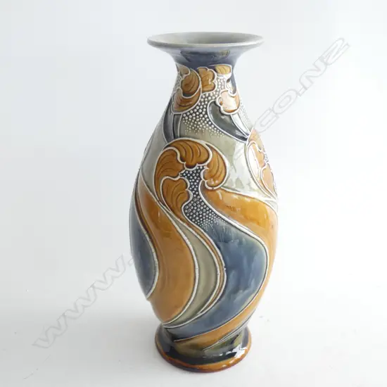 A Nouveau Doulton Lambeth pottery vase by Frank A Butler, ovoid with flaring neck. Caramel, brown, blue tube lined in breaking wave design. Impressed marks and incised initials FAB on base. H.290mm