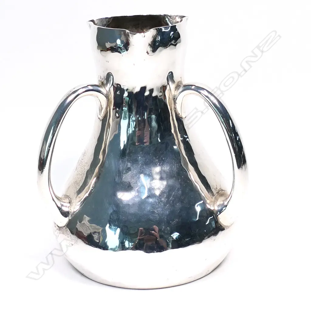 An Arts & Crafts silver tyg form vase. London 1903 by Charles Edwards for the Sussex Goldsmiths Co. Brighton, hammer finished baluster shape with three loop handles. H.145mm. 456gms. Image 1++