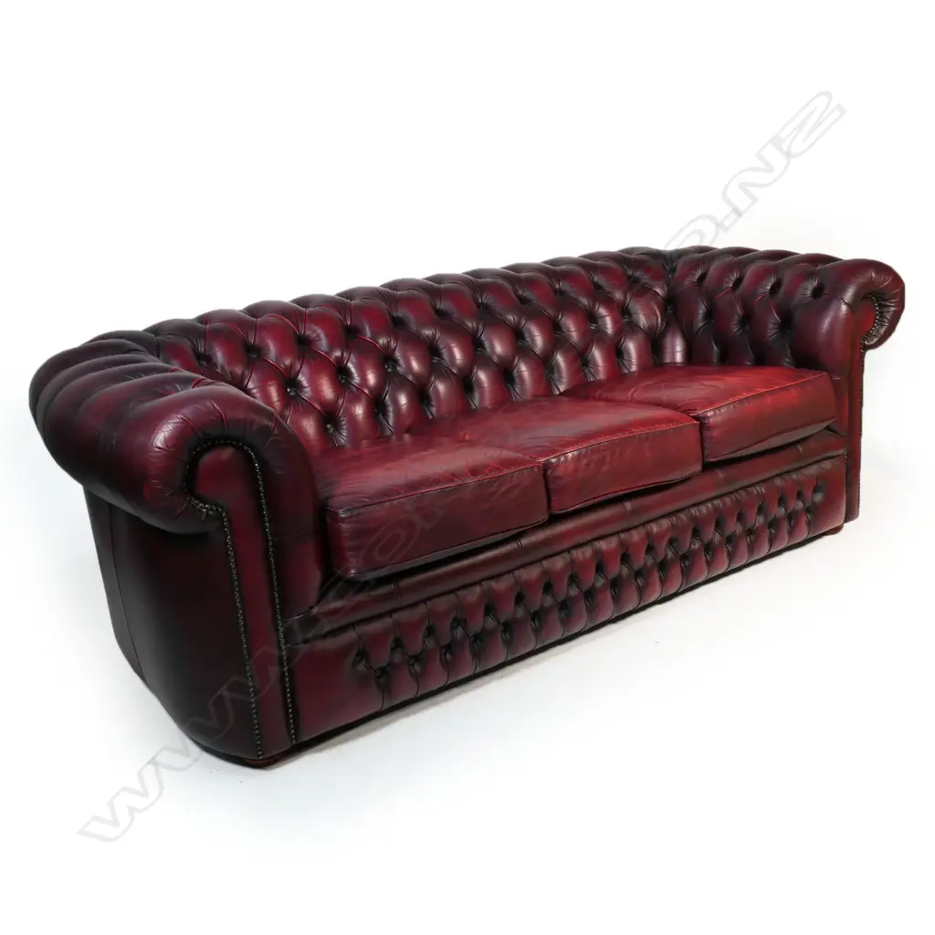 A Gascoigne 'Charles' Chesterfield three-seater sofa, upholstered in burgundy leather. 2140 x 900 x 750mm. Handmade by Gascoigne Leather Centre - an Australian furniture company. Image 1++