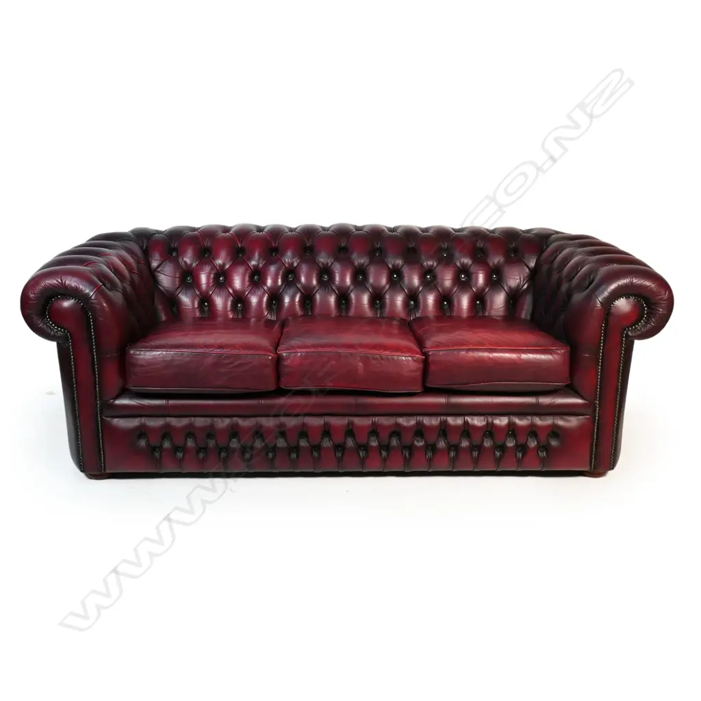 A Gascoigne 'Charles' Chesterfield three-seater sofa, upholstered in burgundy leather. 2140 x 900 x 750mm. Handmade by Gascoigne Leather Centre - an Australian furniture company. Image 1++