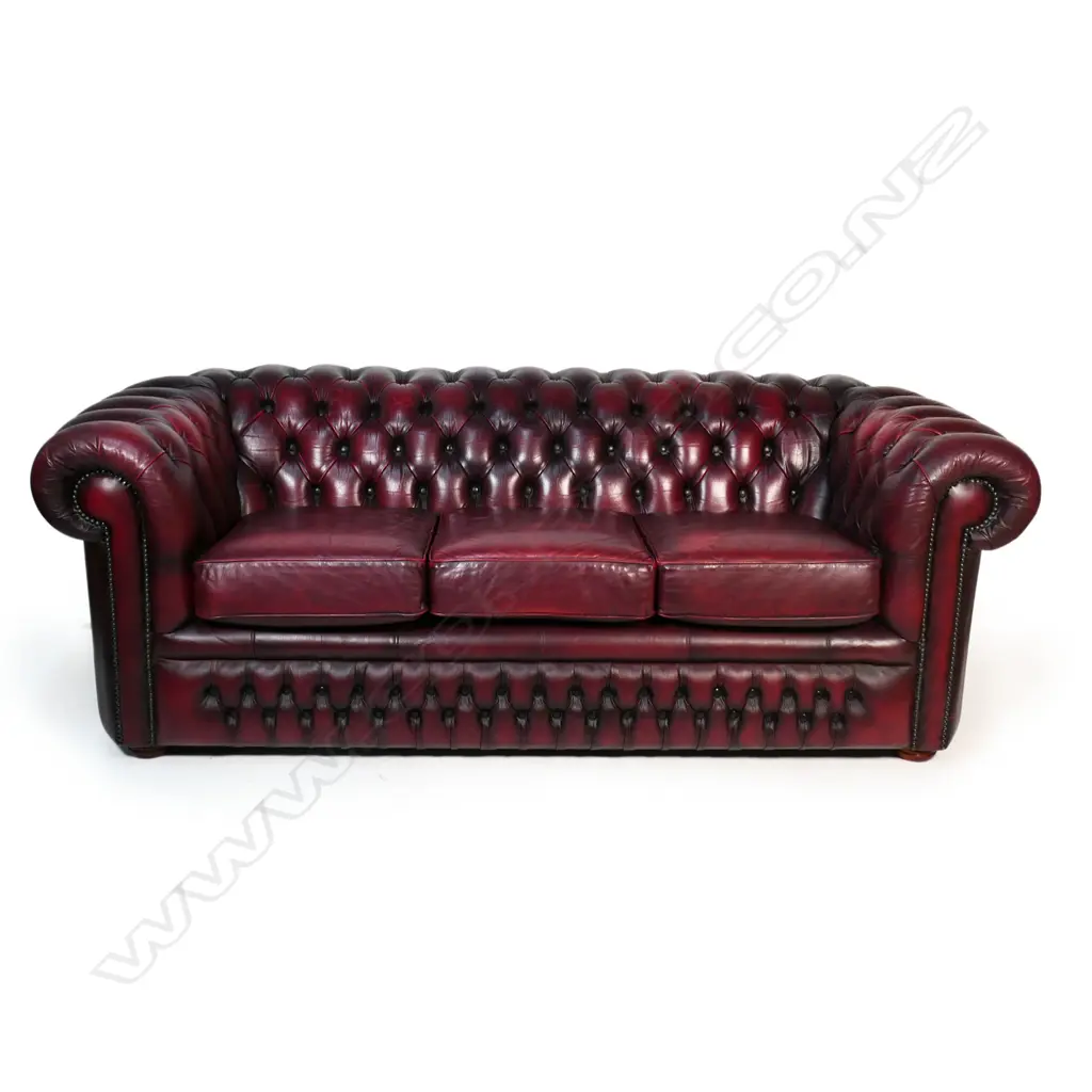 A Gascoigne 'Charles' Chesterfield three-seater sofa, upholstered in burgundy leather. 2140 x 900 x 750mm. Handmade by Gascoigne Leather Centre - an Australian furniture company. Image 1++
