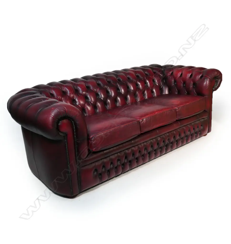 A Gascoigne 'Charles' Chesterfield three-seater sofa, upholstered in burgundy leather. 2140 x 900 x 750mm. Handmade by Gascoigne Leather Centre - an Australian furniture company. Image 1++