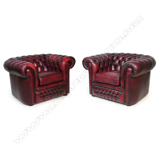 A pair of Gascoigne Chesterfield tub chairs, upholstered in burgundy leather with button-backs. 1100 x 940 x 760mm. Handmade by Gascoigne Leather Centre - an Australian furniture company.