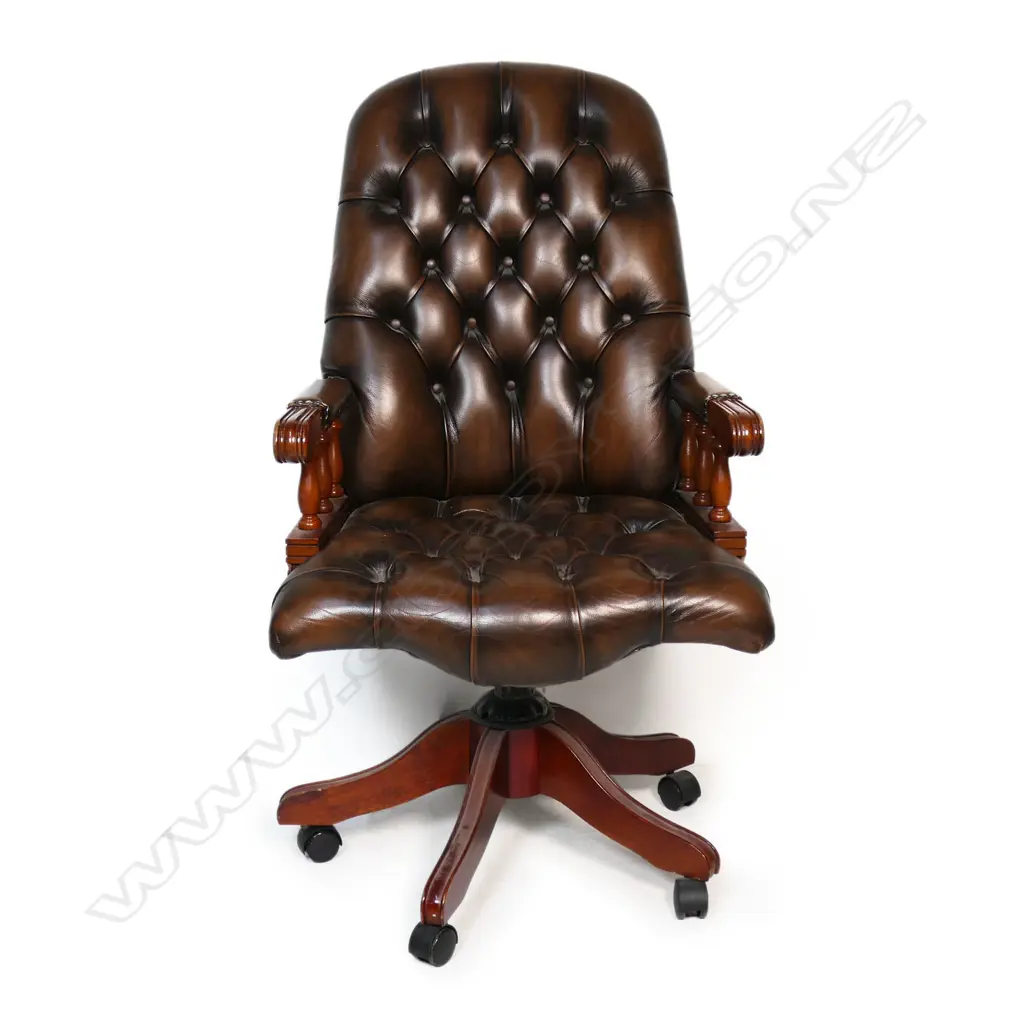 A Mountbatten-style leather buttoned-back swivel chair, in dark brown leather and mahogany. 650 x 480 x 1140mm Image 1++