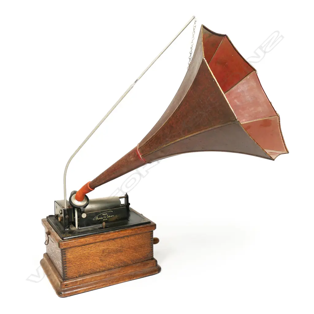 An early 20thC Edison wax roll 'Fireside Phonograph', in original oak case with domed hinged lid. Side wide handle operating, holding charge, apparently working, with maker's name plate with model details. The original red and gilt painted tin octagonal horn with Edison decal. Image 1++