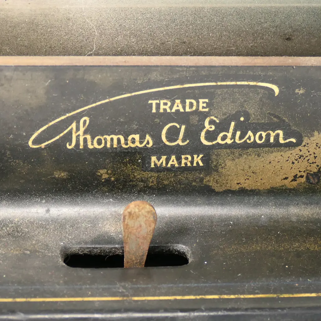 An early 20thC Edison wax roll 'Fireside Phonograph', in original oak case with domed hinged lid. Side wide handle operating, holding charge, apparently working, with maker's name plate with model details. The original red and gilt painted tin octagonal horn with Edison decal. Image 1++