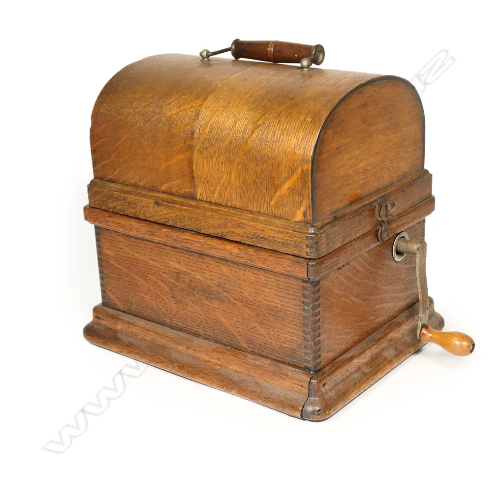 An early 20thC Edison wax roll 'Fireside Phonograph', in original oak case with domed hinged lid. Side wide handle operating, holding charge, apparently working, with maker's name plate with model details. The original red and gilt painted tin octagonal horn with Edison decal. Image 1++