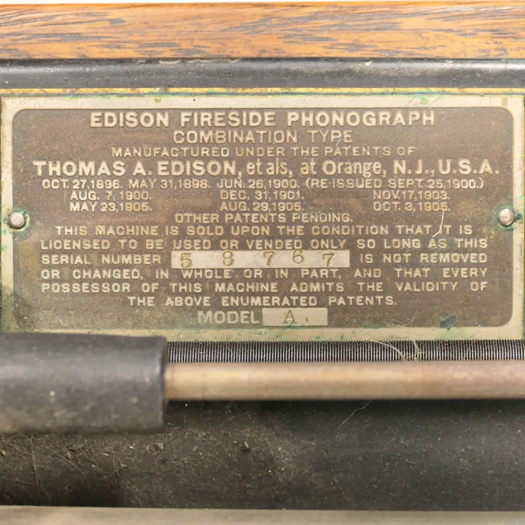 An early 20thC Edison wax roll 'Fireside Phonograph', in original oak case with domed hinged lid. Side wide handle operating, holding charge, apparently working, with maker's name plate with model details. The original red and gilt painted tin octagonal horn with Edison decal. Image 1++