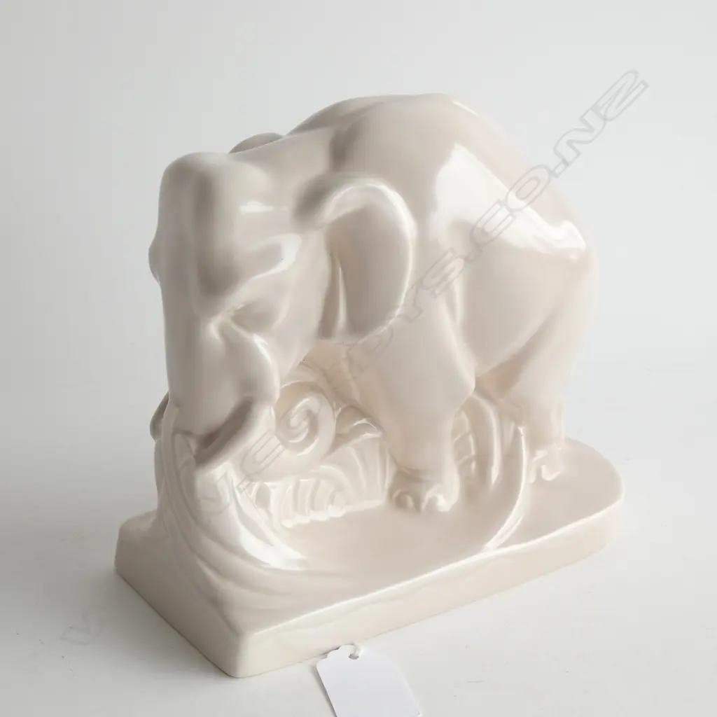 A Poole bookend shaped as elephant. Pale pink-mushroom monochrome glaze. Image 1++