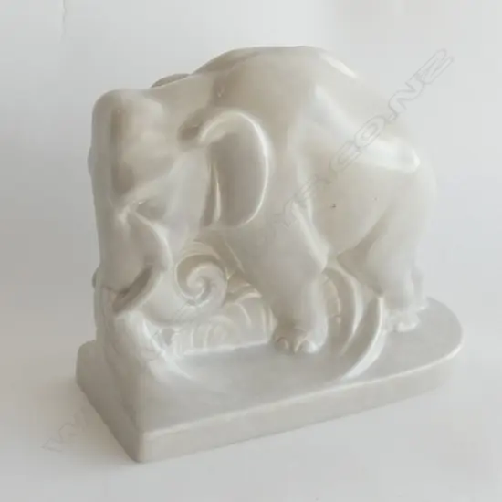 A Poole bookend shaped as elephant. Pale grey monochrome glaze.