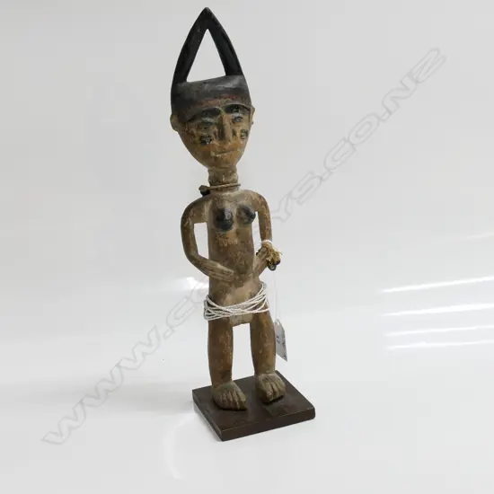 YORUBA BENIN ERE IBEJI WOOD CARVED FEMALE FIGURE with indigo headdress. H.335mm. White fine beads to waist.