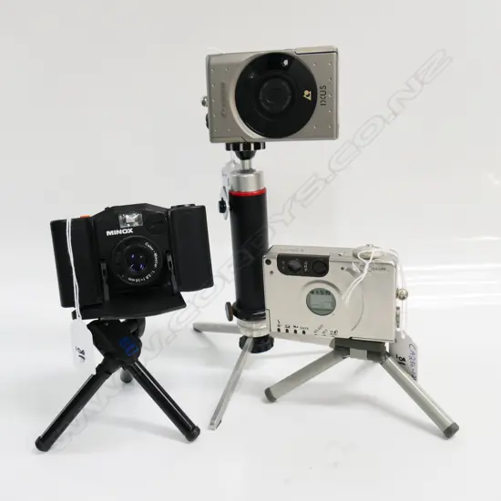3 CAMERAS: CANON IXUS + MINOX 35GL,CANON IXUS II + CASE & MANUAL (on short tripods)