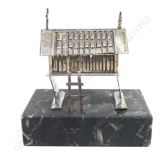 A silver handmade raised church,