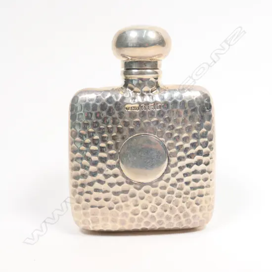 An Edwardian silver dimpled small hip flask,