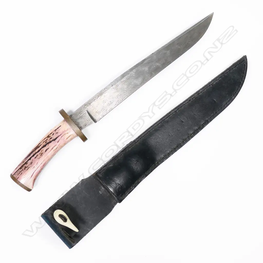Large bowie / hunting knife with scabbard. Made from Damascus steel. Leather scabbard is marked Puttrim NZ.  L.400mm Image 1++