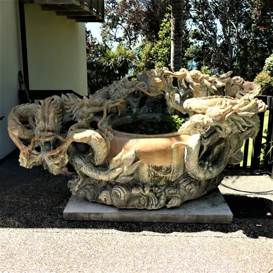 A very large and heavy carved stone Chinese dragon decorated pot