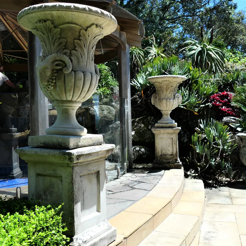 A pair tall concrete classical garden urns on plinth bases Image 1++