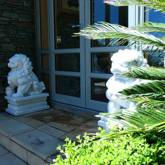 A pair Chinese carved white marble fu dogs