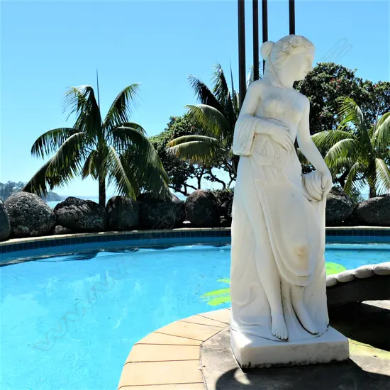 A tall carved marble woman statue
