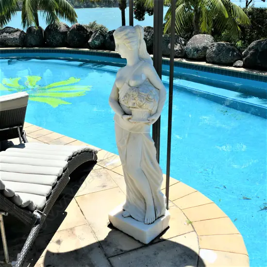 A tall carved marble woman statue