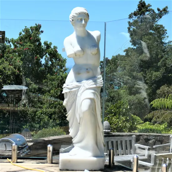 A tall carved marble Venus de milo statue