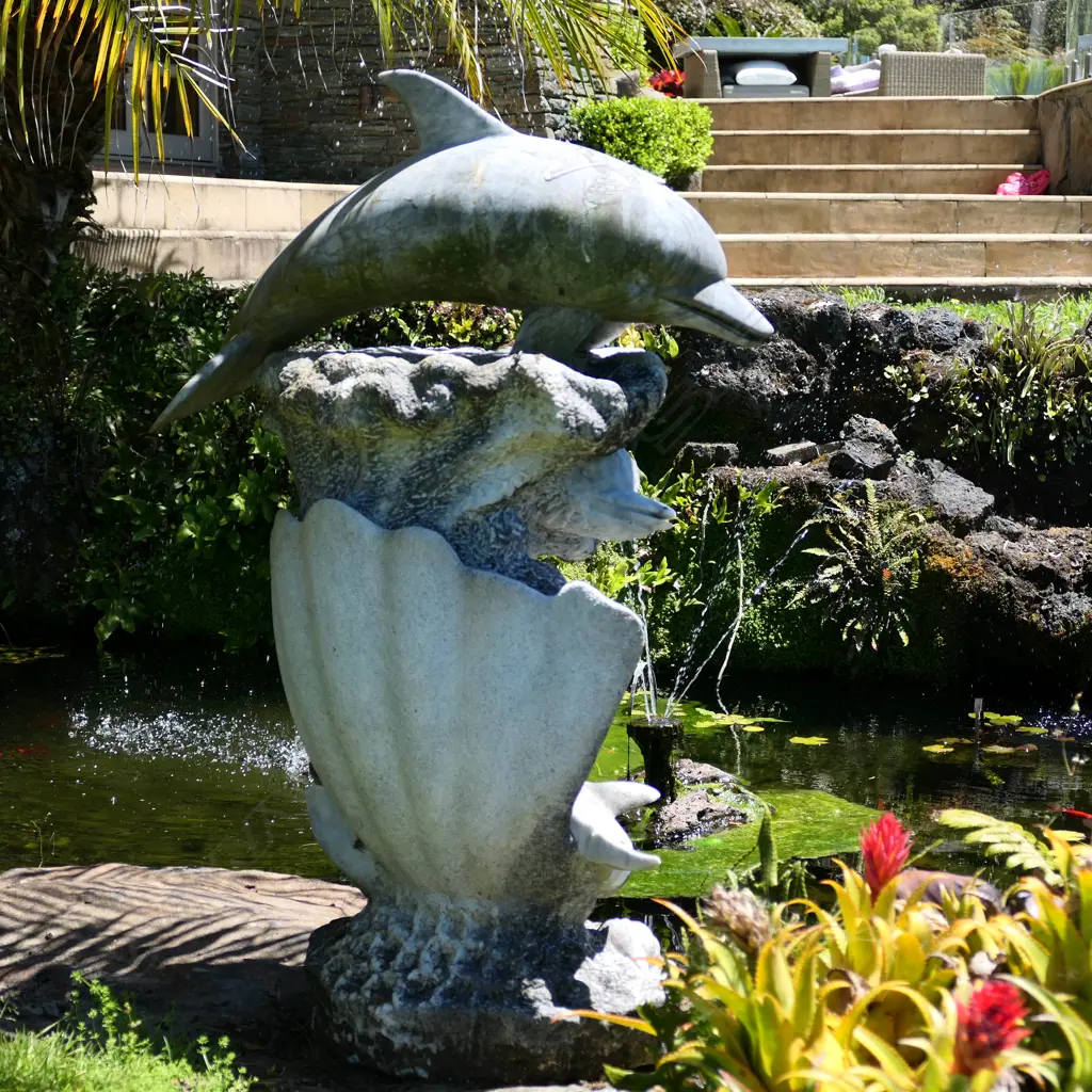 A carved marble dolphin figure group with waves and scallops Image 1++