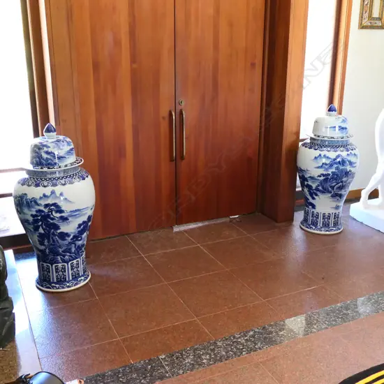 A pair tall Chinese blue and white lidded urns