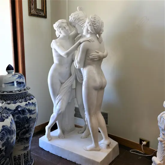 A large carved marble group 'the Three Graces'