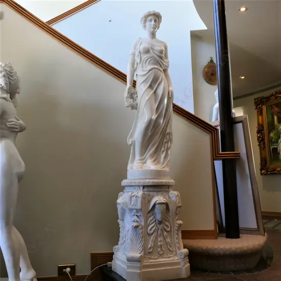 A classical tall roman carved marble standing woman