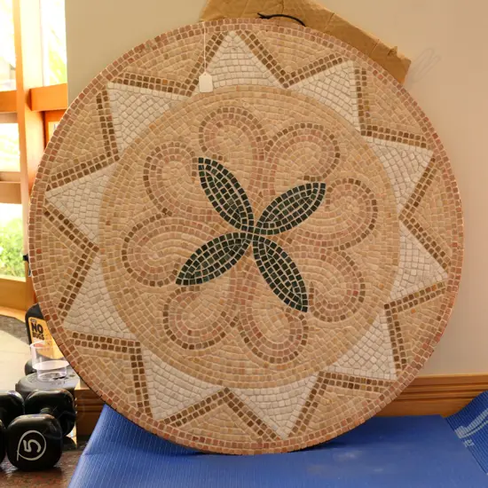 A circular mosaic tiled wall hanging