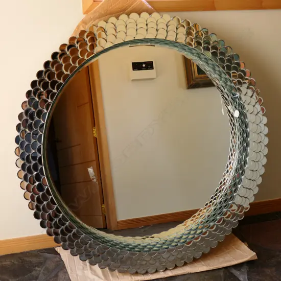 A large circular mirror w/ mirror scale frame