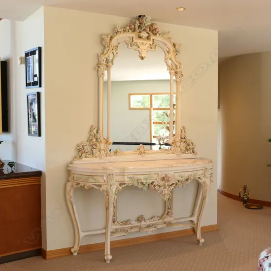 A contemporary antique style Venetian mirrored console