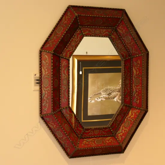 An antique cushion style wall mirror