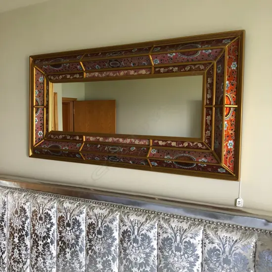 An antique style cushion mirror