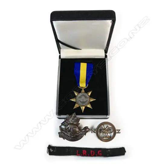 NZ Long Range Desert Group badge (possibly a reunion badge) and an embroidered L.R.D.G New Zealand embroidered title along with an RSA 90th anniversary medal in box and a British-American Squadron of the King's Colonials cap badge..