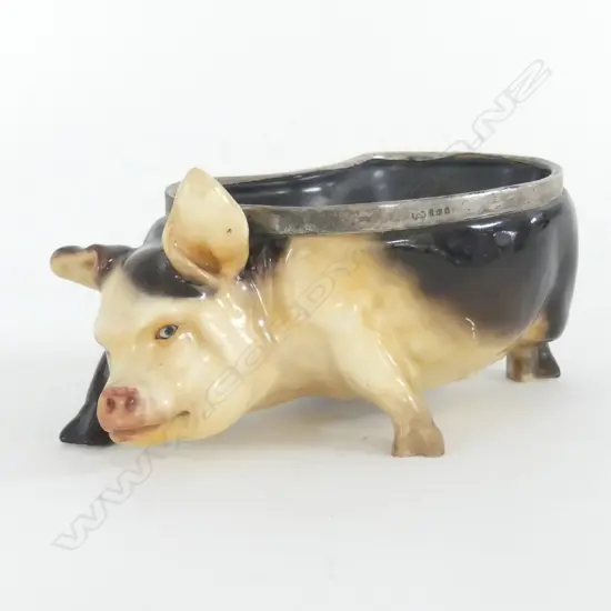 DOULTON FIGURAL BOWL IN THE FORM OF A PIG WITH STERLING SILVER RIM. LONDON 1914. L.175mm