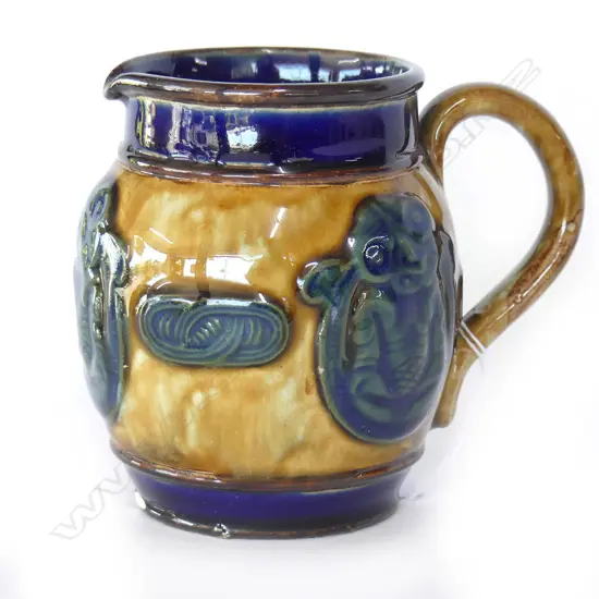 SMALL DOULTON MAORI ART JUG WITH 3 TIKI PANELS H.80mm (hairline cracks to rim, chip to base))
